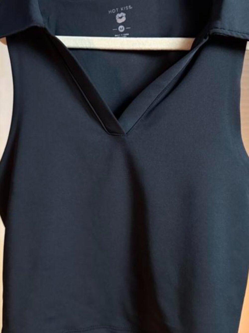 Black sleeveless collared top